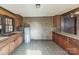 A vintage kitchen with wood cabinets, patterned wallpaper, and an integrated double sink at 3467 Clearview Ln, Maiden, NC 28650