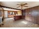 Open concept kitchen with wood paneling, tile floor, ceiling fan and wood cabinets at 3467 Clearview Ln, Maiden, NC 28650
