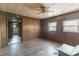 Cozy living room featuring wood-paneled walls, hardwood floors, and multiple windows for natural light at 3467 Clearview Ln, Maiden, NC 28650