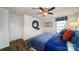 Well-lit bedroom featuring a ceiling fan, dresser, decorative mirror, and two windows with a blue patterned valance at 3736 13Th Ne St, Hickory, NC 28601