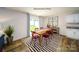 A well-lit dining area features an elegant table, red chairs, and large sliding glass doors at 3736 13Th Ne St, Hickory, NC 28601