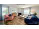 Open-concept living room with fireplace, large windows and modern fixtures at 3736 13Th Ne St, Hickory, NC 28601