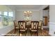 Formal dining room with hardwood floors, a large window, and seating for six at 113 Asmodean Ln, Troutman, NC 28166
