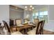 Open dining room with wood floors, a chandelier, and seating for six at 113 Asmodean Ln, Troutman, NC 28166