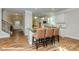 Kitchen island with bar stool seating, granite countertops, stainless steel appliances and hardwood floors at 113 Asmodean Ln, Troutman, NC 28166