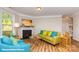 View of the living room featuring cozy seating, a fireplace, and natural light from the windows at 113 Asmodean Ln, Troutman, NC 28166
