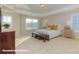 Bright main bedroom with neutral tones, tray ceilings, and large windows at 113 Asmodean Ln, Troutman, NC 28166