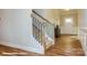 Carpeted staircase with a wood handrail leading to the upper level of the home at 113 Asmodean Ln, Troutman, NC 28166