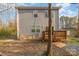 Two-story home showcases a wood deck, a gray siding exterior, and a spacious backyard with mature trees at 3944 Wade E Morgan Rd, Charlotte, NC 28269
