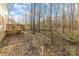 Discover serenity in this backyard with a wooden deck, gravel area, and an abundance of mature trees at 3944 Wade E Morgan Rd, Charlotte, NC 28269