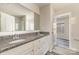Bathroom featuring double vanity with granite counters and a glass-enclosed shower at 3944 Wade E Morgan Rd, Charlotte, NC 28269