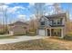 Exterior of a two-story gray house with an extended driveway and a detached garage in the backyard at 3944 Wade E Morgan Rd, Charlotte, NC 28269
