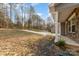 A view of the front yard with the house on the right, and the driveway extending to the detached garage at 3944 Wade E Morgan Rd, Charlotte, NC 28269