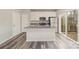 Kitchen featuring white cabinets, stainless appliances, a kitchen island, and sliding door access to a deck at 3944 Wade E Morgan Rd, Charlotte, NC 28269