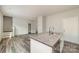 A modern kitchen island with a granite countertop and stainless steel appliances, with wood-look flooring at 3944 Wade E Morgan Rd, Charlotte, NC 28269
