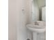 Simple powder room with pedestal sink and decorative mirror at 3944 Wade E Morgan Rd, Charlotte, NC 28269