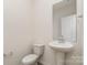 Half bathroom featuring a sink, mirror, and toilet at 411 Wintergreen Ct # 2, Kings Mountain, NC 28086