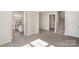 Open-concept living area with new floors, white walls, and stairs at 411 Wintergreen Ct # 2, Kings Mountain, NC 28086