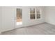 Well-lit room with three windows and a door to the outside at 411 Wintergreen Ct # 2, Kings Mountain, NC 28086