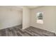 Bright bedroom featuring stylish flooring, neutral paint, and a large window offering natural light and outdoor views at 418 Wintergreen Ct, Kings Mountain, NC 28086