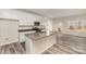 Bright kitchen featuring an island, stainless steel appliances and ample white cabinetry and exterior access at 418 Wintergreen Ct, Kings Mountain, NC 28086