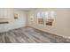 Open-concept living space with views to the outdoor deck, and hardwood style flooring at 418 Wintergreen Ct, Kings Mountain, NC 28086
