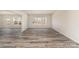 Expansive living room featuring stylish flooring, neutral walls, and ample natural light streaming through the windows at 418 Wintergreen Ct, Kings Mountain, NC 28086