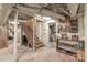 Unfinished basement with stairs, white painted brick, shelving, and access to storage area, a versatile space at 600 S Central Ave, Belmont, NC 28012