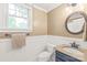 Bathroom featuring beadboard paneling, neutral walls, single sink and decorative mirror at 600 S Central Ave, Belmont, NC 28012