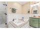 Elegant bathroom featuring a soaking tub with a wooden tray and a separate glass-enclosed shower at 600 S Central Ave, Belmont, NC 28012