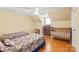 Shared bedroom with hardwood floors, a ceiling fan, and two twin beds, plus a crib at 600 S Central Ave, Belmont, NC 28012