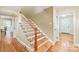 Welcoming entryway featuring hardwood floors and a staircase with wood treads and white risers at 600 S Central Ave, Belmont, NC 28012