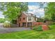 A two-story brick home featuring a multi-car garage, mature landscaping and a winding driveway at 600 S Central Ave, Belmont, NC 28012