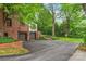 Brick home featuring a garage, mature landscaping, and an asphalt driveway at 600 S Central Ave, Belmont, NC 28012