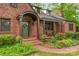 Quaint front facade with brick pathway and covered entryway surrounded by lush greenery at 600 S Central Ave, Belmont, NC 28012