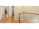 Upstairs hallway showcasing hardwood floors, white trim, and access to various rooms at 600 S Central Ave, Belmont, NC 28012