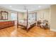 Spacious main bedroom with hardwood floors, a four-poster bed, and natural light at 600 S Central Ave, Belmont, NC 28012