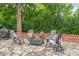 Cozy backyard patio featuring a fire pit, surrounded by comfortable seating and lush greenery at 600 S Central Ave, Belmont, NC 28012
