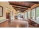 Bright sunroom with tile floors, wood ceiling beams, and large windows overlooking the backyard at 600 S Central Ave, Belmont, NC 28012