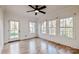 Bright, open bedroom featuring hardwood floors and windows offering outdoor views at 7403 Grassy Ridge Rd, Denver, NC 28037