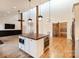 Bright living room with high ceilings, modern lighting, island, and a sliding barn door to the pantry at 7403 Grassy Ridge Rd, Denver, NC 28037