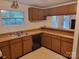 Practical kitchen with classic wood cabinetry, a double sink, and open layout to other rooms at 7597 Webbs Rd, Denver, NC 28037