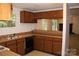 Efficient kitchen with wooden cabinets, double sink, and open serving area, ideal for entertaining at 7597 Webbs Rd, Denver, NC 28037