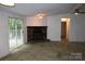 Spacious living room with a stone fireplace and sliding glass doors leading to the outdoors at 7597 Webbs Rd, Denver, NC 28037