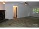 Expansive living room featuring a stone fireplace and a bright window with natural light at 7597 Webbs Rd, Denver, NC 28037