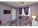 Bedroom with bed, TV, and purple walls at 8364 Chaceview Ct, Charlotte, NC 28269