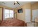 Well-lit bedroom with a large window, vaulted ceiling, wall-mounted TV, and a comfortable queen-sized bed at 8364 Chaceview Ct, Charlotte, NC 28269