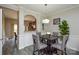 Chic dining area featuring stylish chairs, modern lighting, and an open view to the kitchen at 8364 Chaceview Ct, Charlotte, NC 28269