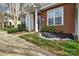 Charming townhome entrance with brick facade, lush landscaping, and decorative stone accents at 8364 Chaceview Ct, Charlotte, NC 28269