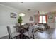 Open-concept living area with a dining table, comfortable seating, and bright lighting at 8364 Chaceview Ct, Charlotte, NC 28269